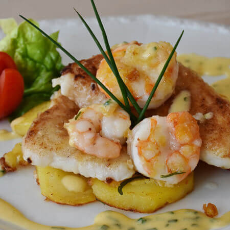 a close up of prawns on toast in haute cuisine style