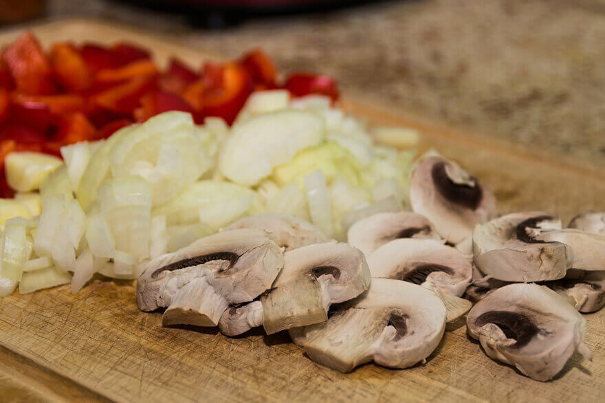 close up of chopped veg including on wooden board