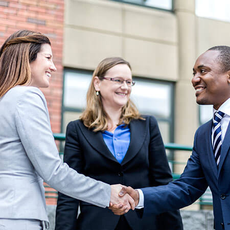 two business people shake hands as standard business etiquette in ireland