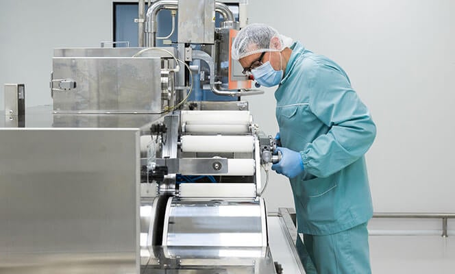 pharmaceutical industry worker in green gowns