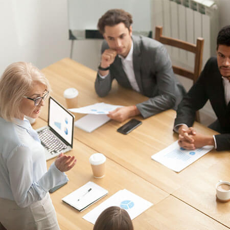 four people sit at a pine desk in a modern office typical of dublin's startup ecosystem