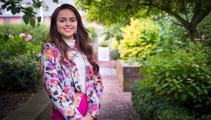 ailbhe keane of izzy wheels smiles and wears a floral blazer