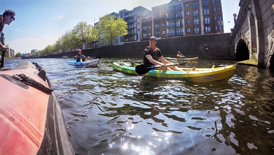 A tour group Kyaking along Dublin's River Liffey