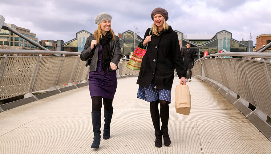 two women cross samuel beckett bridge in the docklands