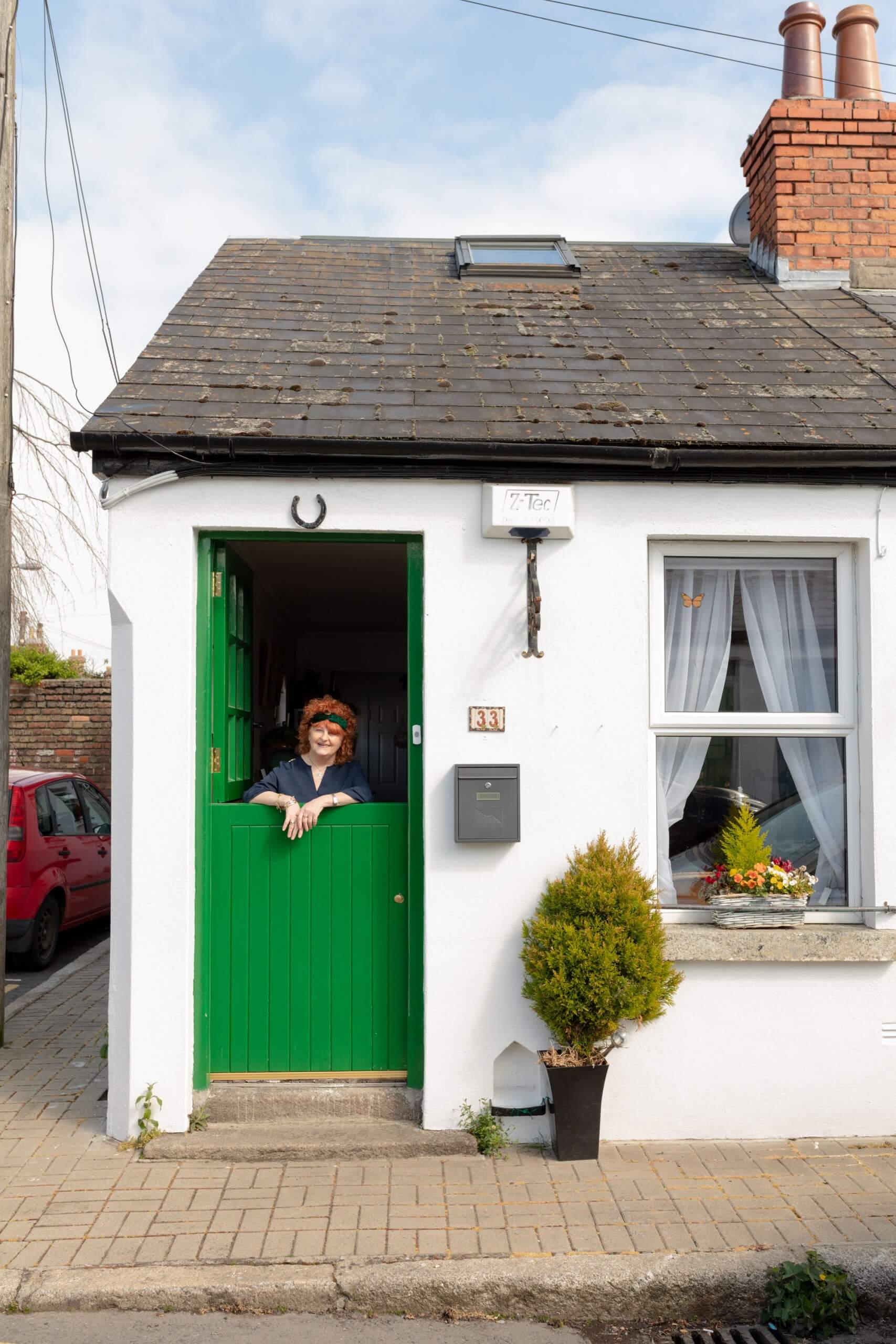 A woman stands in her front door