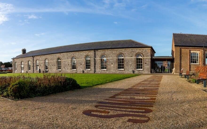 the modern gardens leading up to the grey soldiers barracks