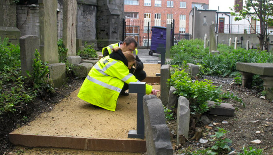 Inspecting the headstones at St James' graveyard.