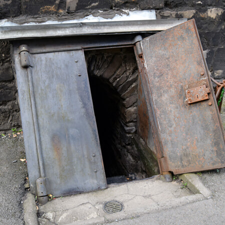 the rusty, metal doors guarding the steps to the crypts of St Michan's church