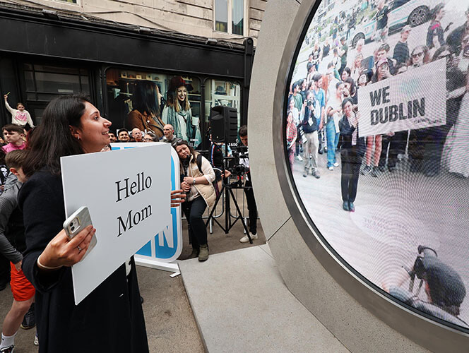 A daughter greets her mother via the portal from Dublin to New York