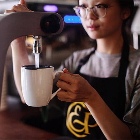 A cup of tea being prepared in a café